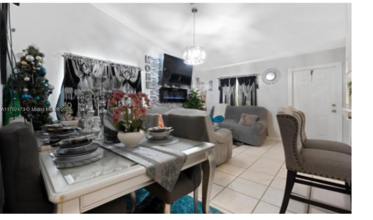 11233 Model Circle West Boca Raton, FL 33428 - Photo 11 of 13 a living room with furniture a flat screen tv and a dining table