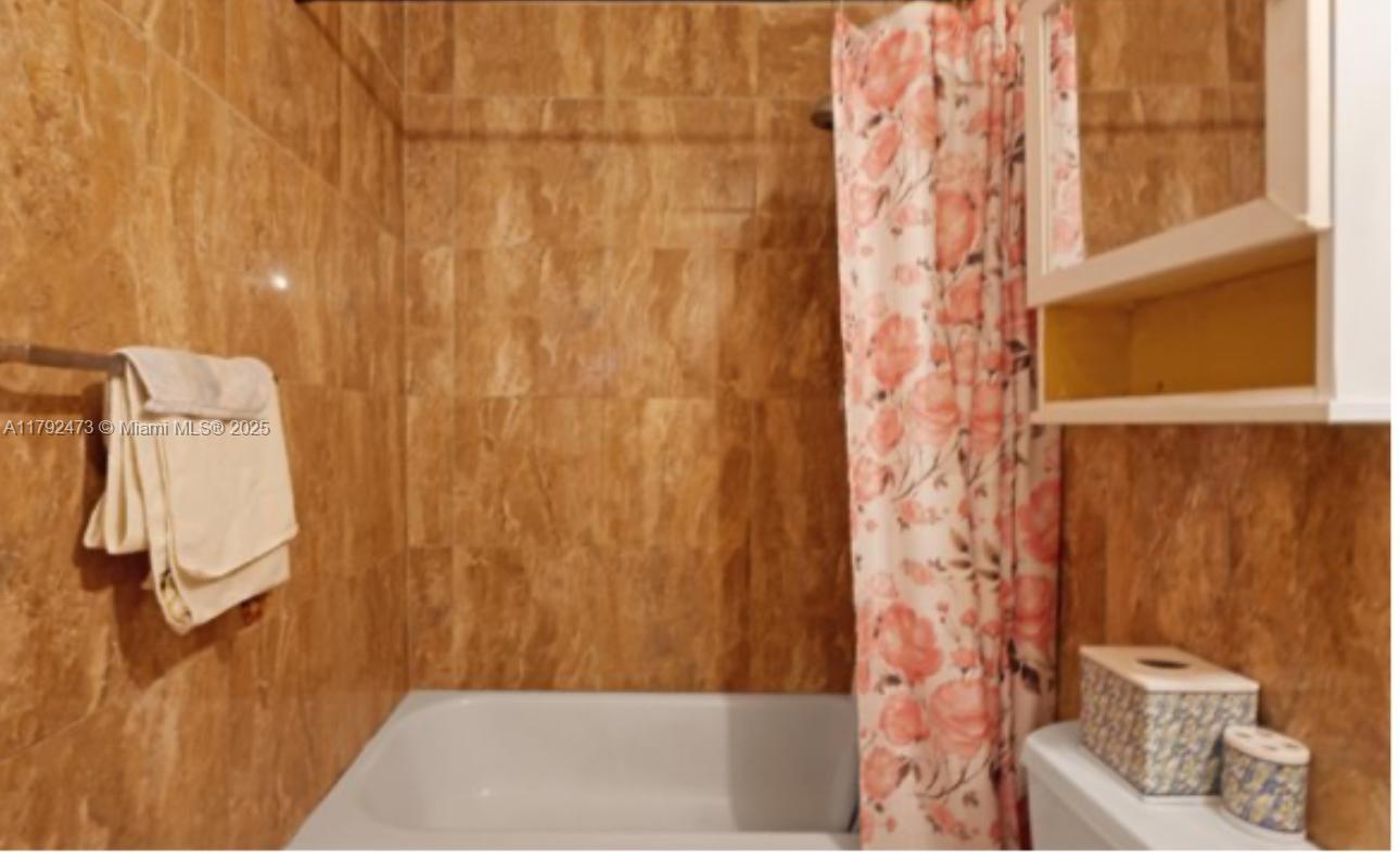 11233 Model Circle West Boca Raton, FL 33428 - Photo 6 of 13 a bathroom with a shower curtain