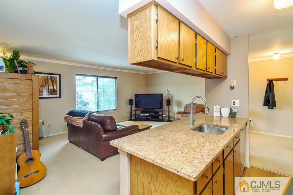 a kitchen with stainless steel appliances granite countertop a sink and a refrigerator