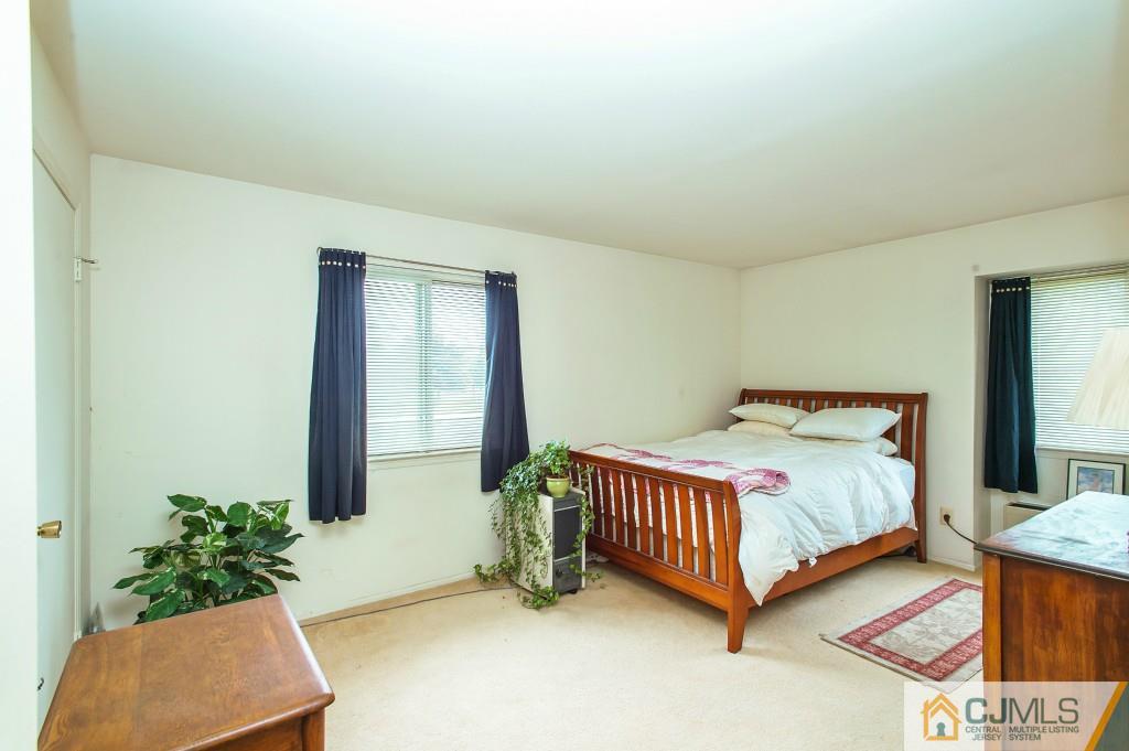 52 Bolton Court Somerset, NJ 08873 - Photo 12 of 18 a room with a bed and a potted plant