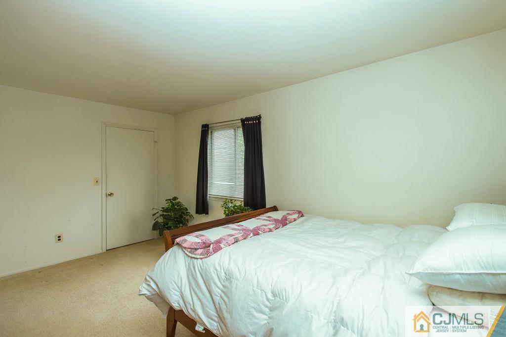 52 Bolton Court Somerset, NJ 08873 - Photo 14 of 18 a bedroom with a bed and a mirror