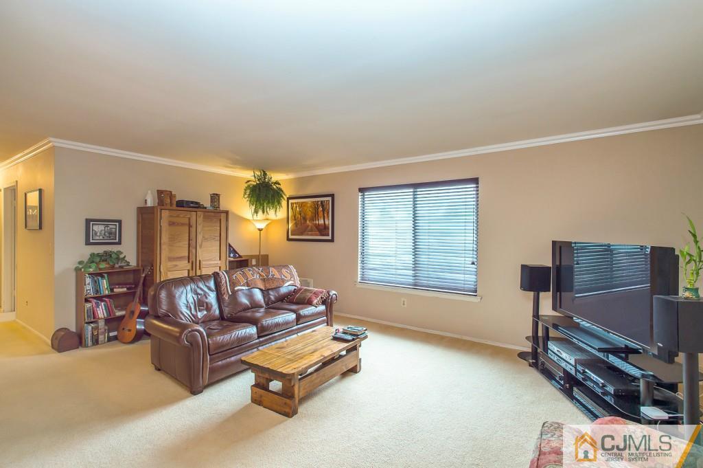 52 Bolton Court Somerset, NJ 08873 - Photo 5 of 18 a living room with furniture a flat screen tv and a window