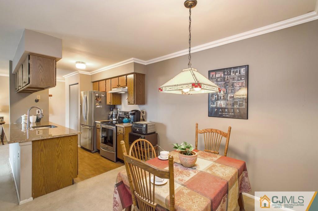 52 Bolton Court Somerset, NJ 08873 - Photo 6 of 18 a dining room with furniture a chandelier and window
