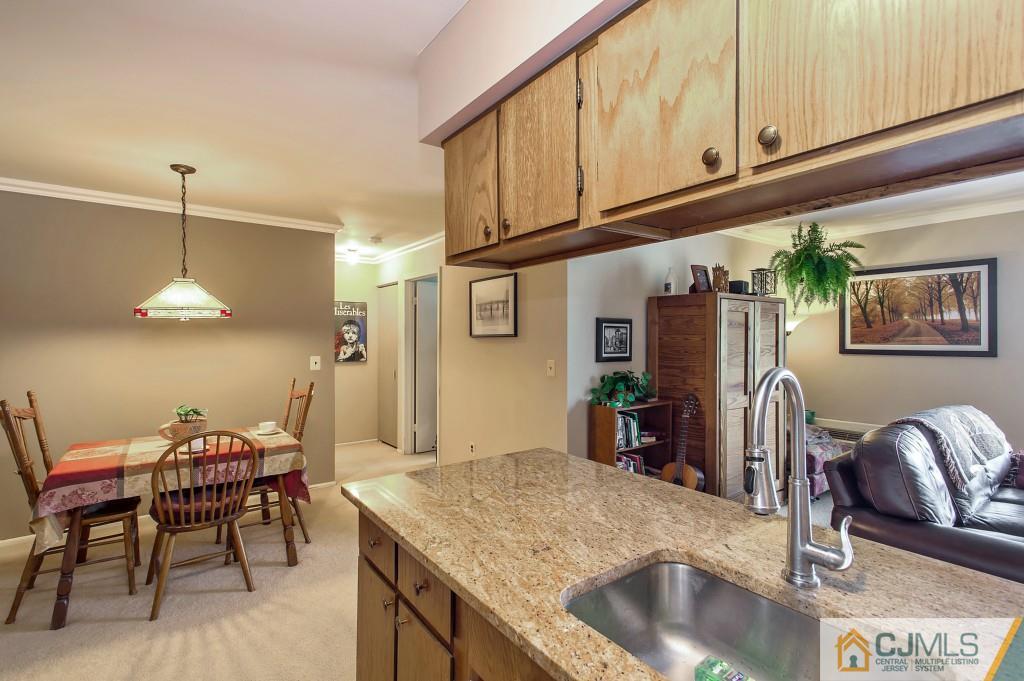 52 Bolton Court Somerset, NJ 08873 - Photo 8 of 18 a kitchen with stainless steel appliances granite countertop a sink and a refrigerator