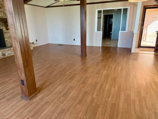a room with a large window and bed