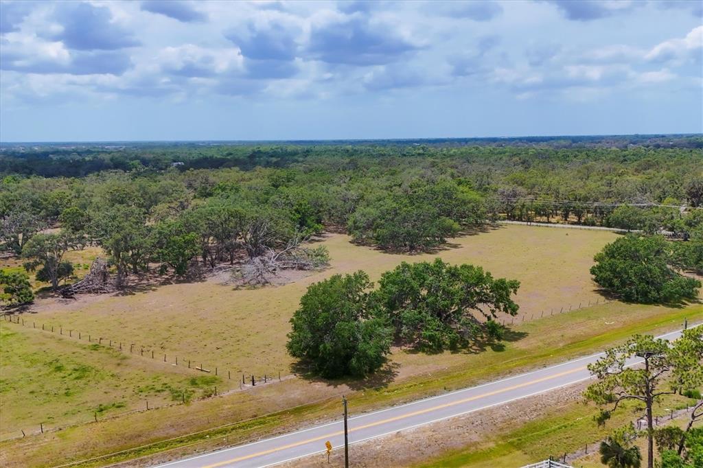 6720 Jim Davis Road Parrish, FL 34219 - Photo 13 of 16 a view of a lake with a yard