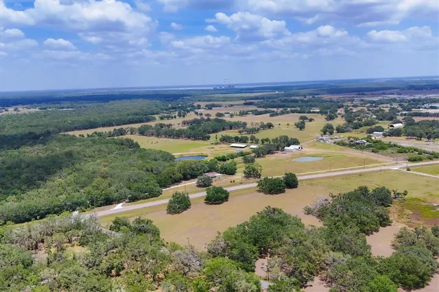 an aerial view of lake and residential houses with outdoor space