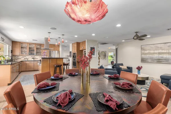 a view of patio with a table and chairs and potted plants