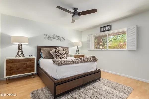 a bathroom with a granite countertop sink toilet and mirror