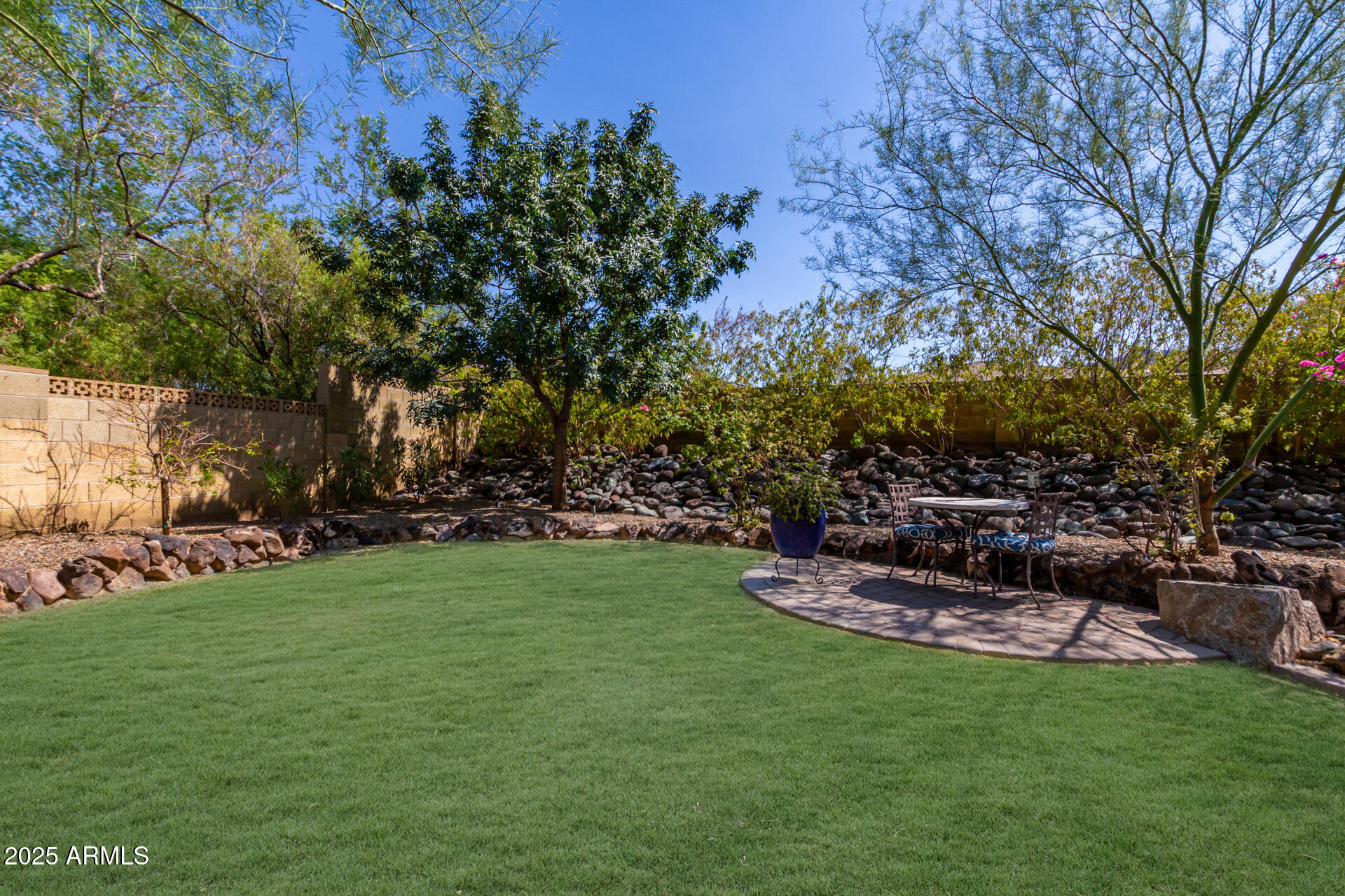 2909 East Las Rocas Drive Phoenix, AZ 85028 - Photo 31 of 48 a backyard of a house with table and chairs
