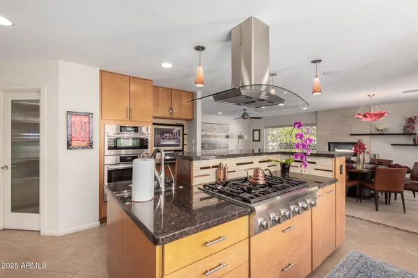 a kitchen with stainless steel appliances granite countertop a sink stove and refrigerator