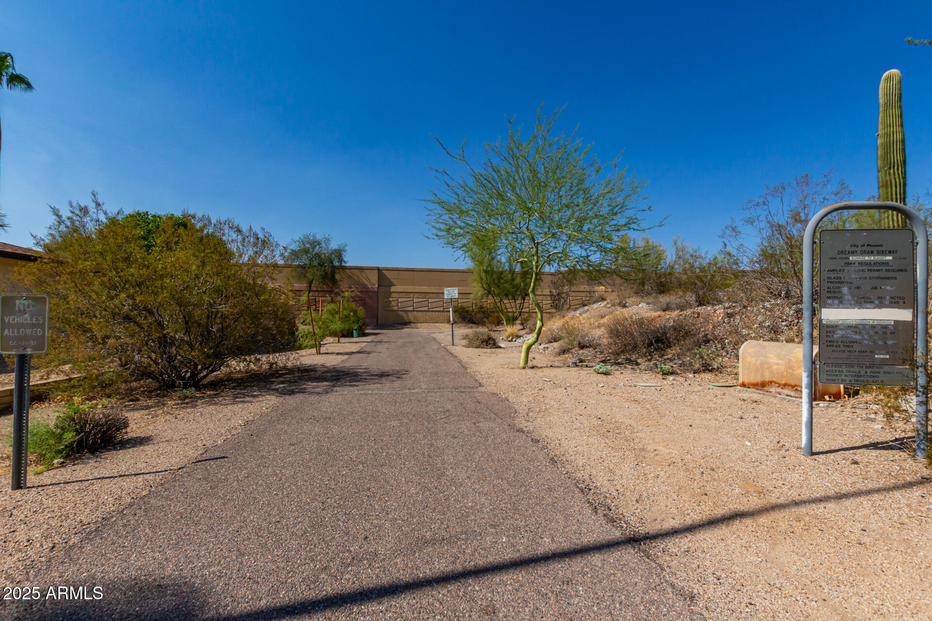 2909 East Las Rocas Drive Phoenix, AZ 85028 - Photo 47 of 48 a backyard of a house with table and chairs under an umbrella