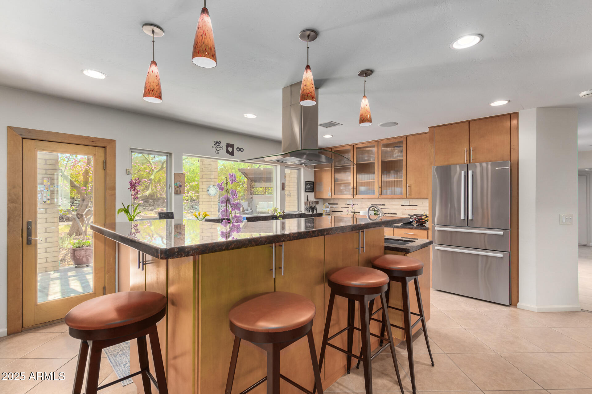 2909 East Las Rocas Drive Phoenix, AZ 85028 - Photo 6 of 48 a kitchen with stainless steel appliances kitchen island granite countertop a table and chairs in it
