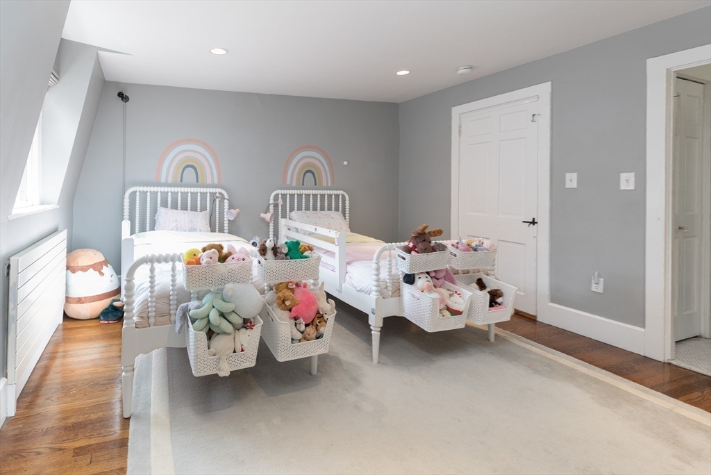 3 River St Place Boston, MA 02114 - Photo 16 of 28 a bedroom with furniture and a chandelier