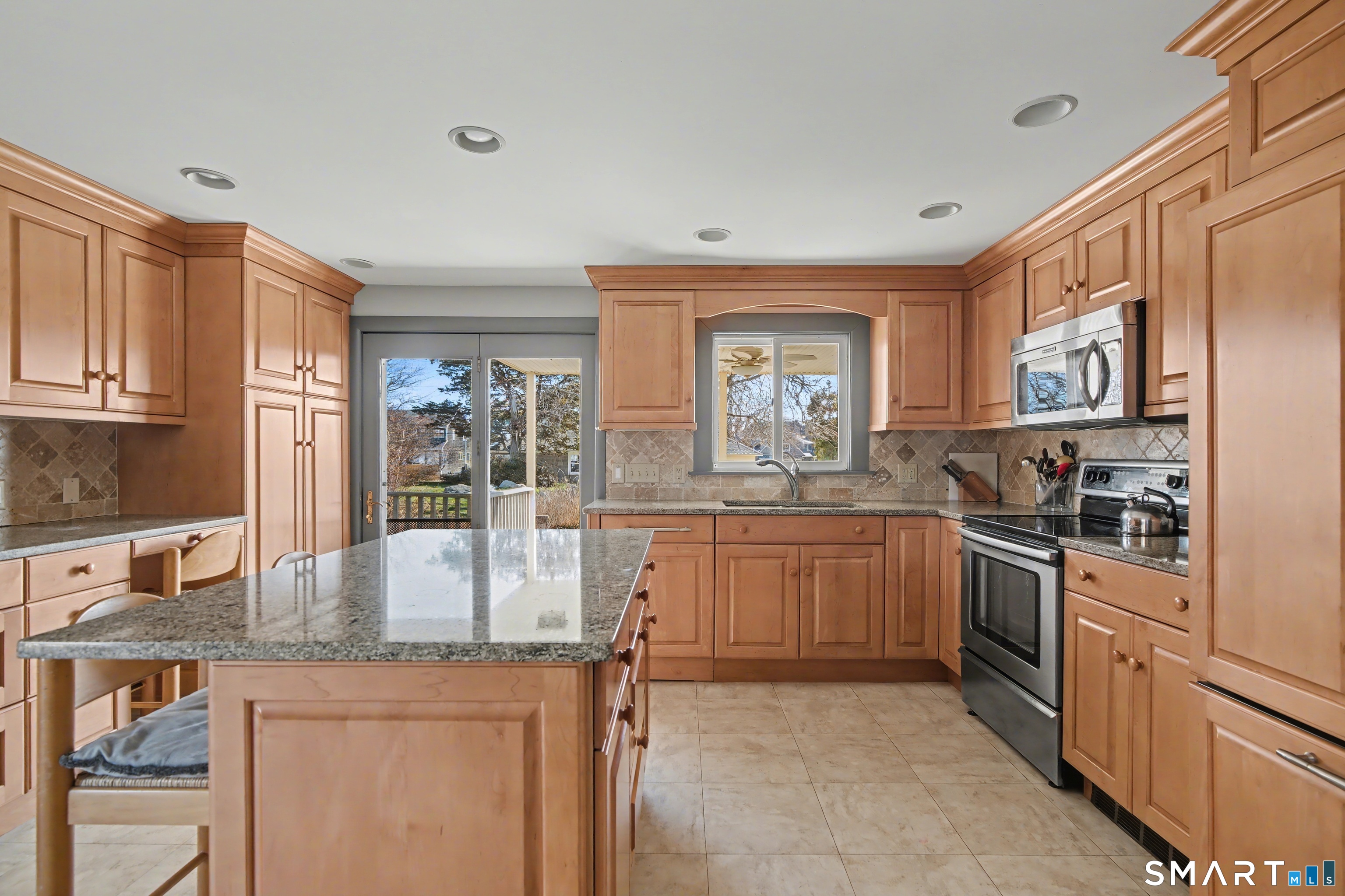 217 West Shore Avenue Groton, CT 06340 - Photo 12 of 34 a kitchen with granite countertop a stove top oven sink and cabinets