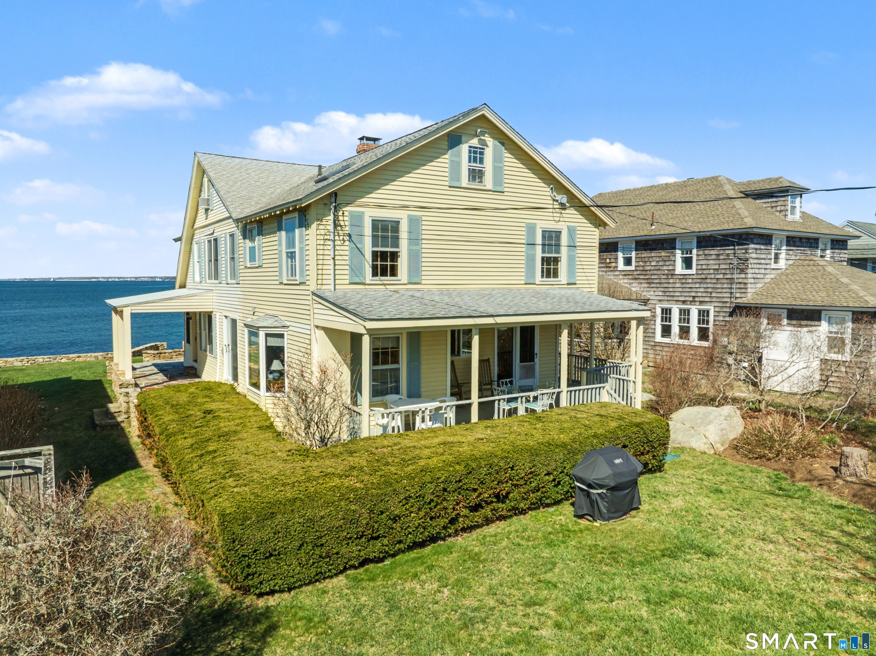 217 West Shore Avenue Groton, CT 06340 - Photo 4 of 34 a front view of a house with a yard table and chairs
