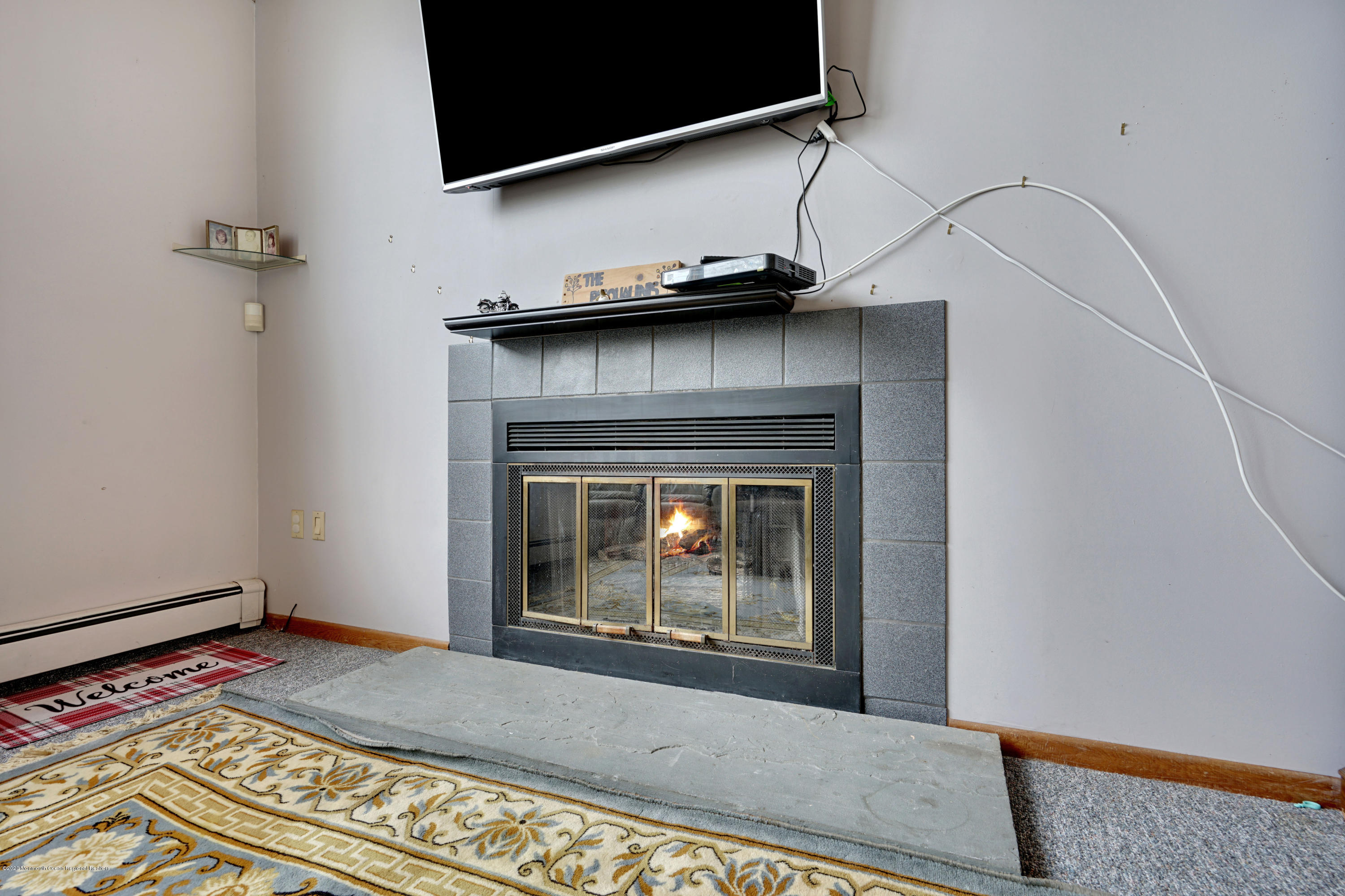 1761 Whitcomb Road Forked River, NJ 08731 - Photo 11 of 41 a living room with a fireplace