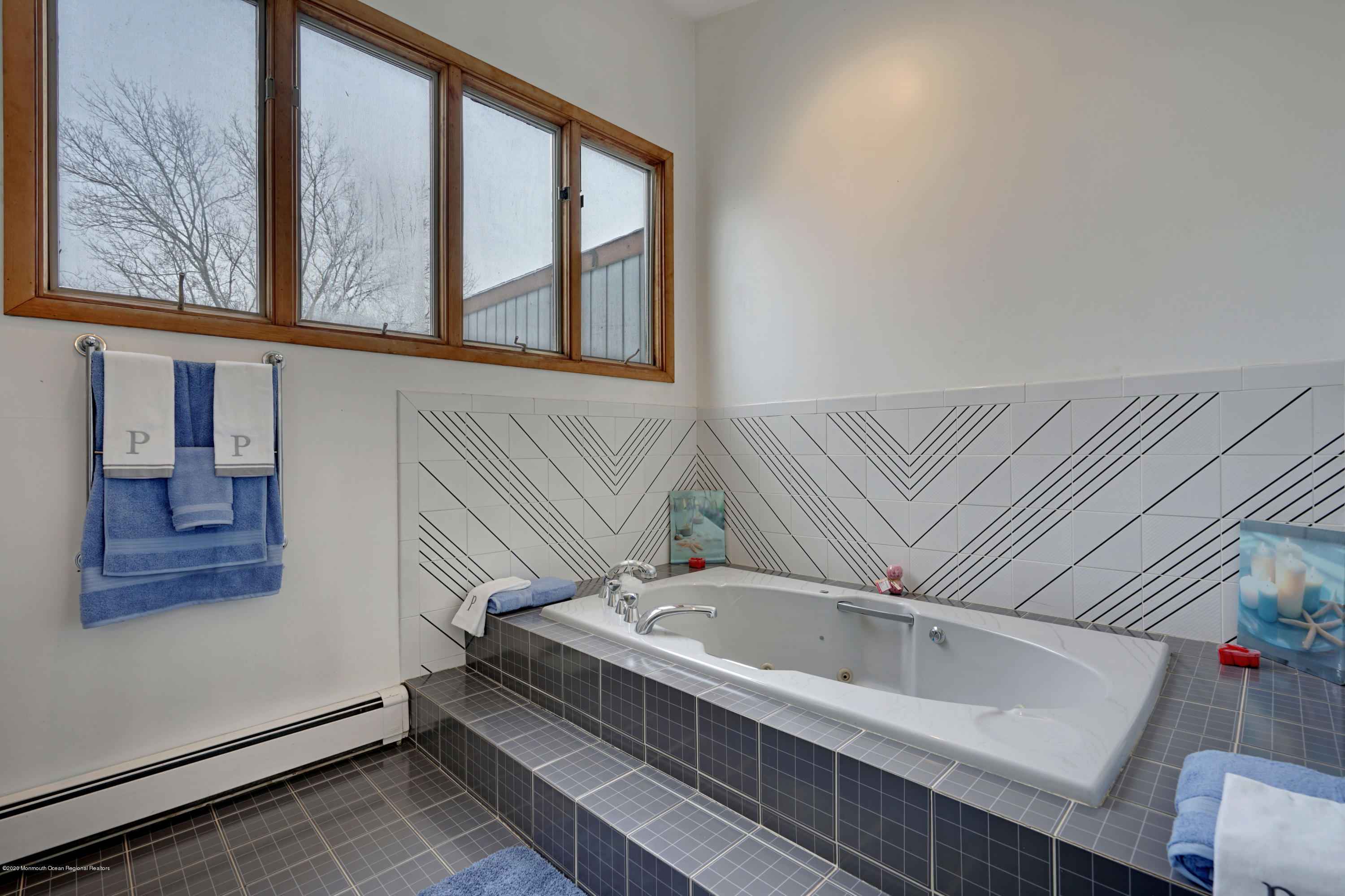 1761 Whitcomb Road Forked River, NJ 08731 - Photo 32 of 41 a bathroom with a bathtub and a window
