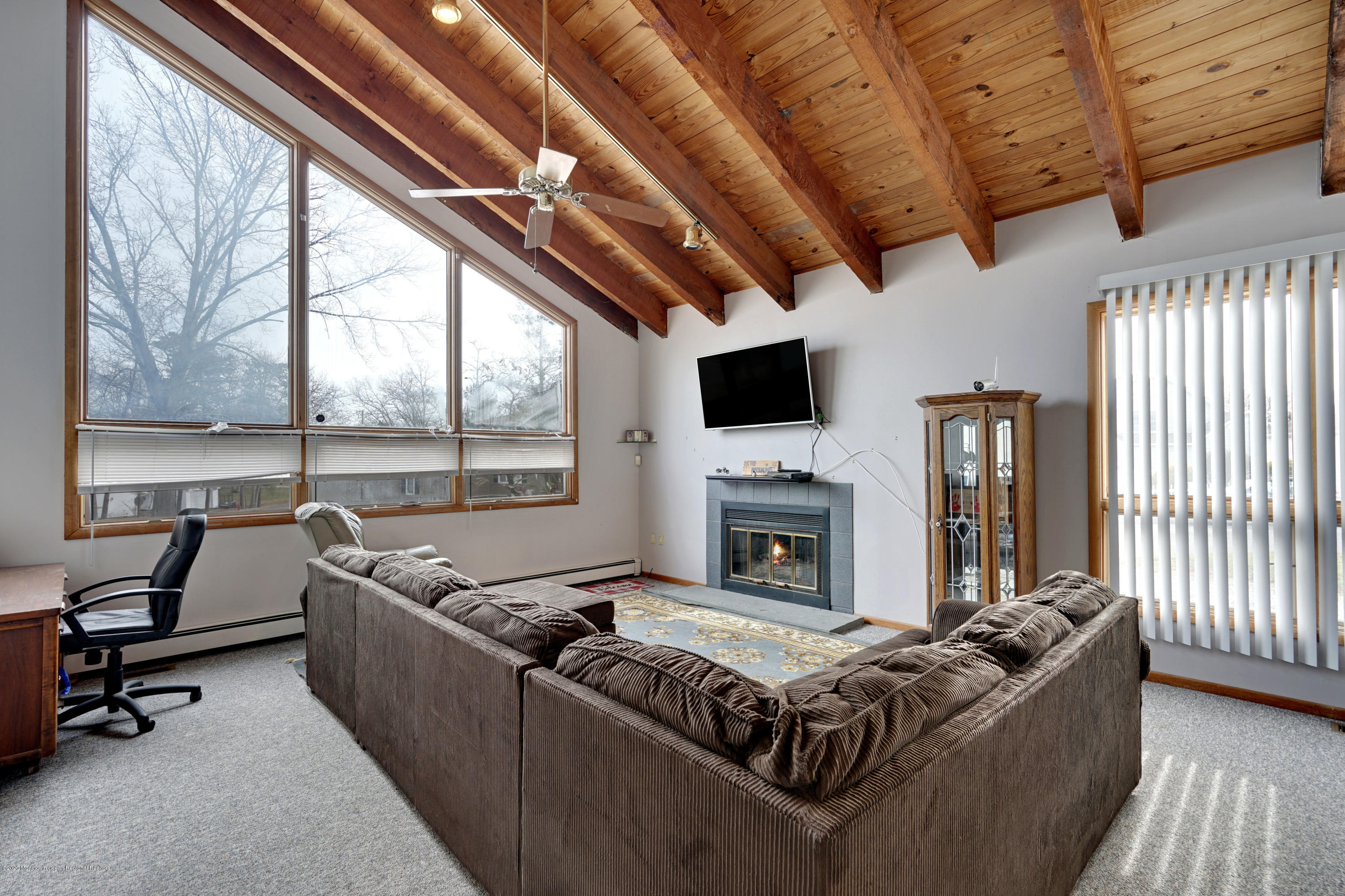 1761 Whitcomb Road Forked River, NJ 08731 - Photo 9 of 41 a living room with furniture a flat screen tv and a fireplace