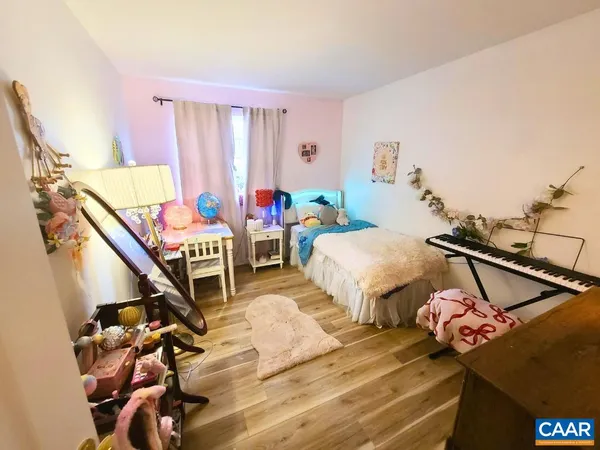 a bedroom with furniture and a mirror