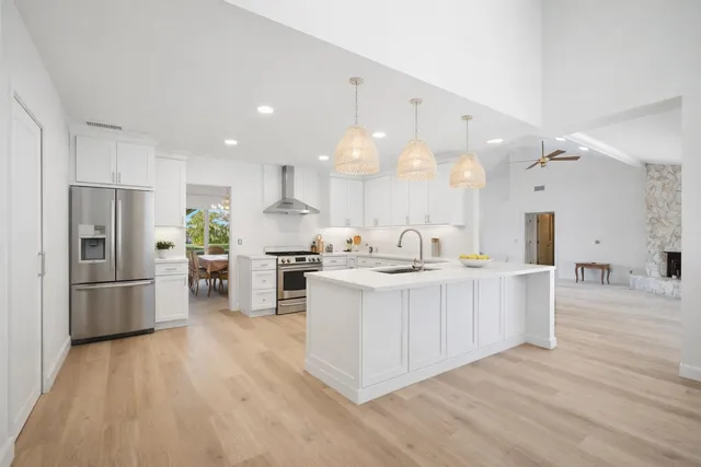 a spacious bedroom with a bed and a ceiling fan