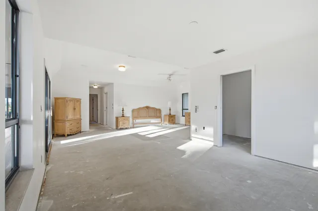 a living room with furniture and a floor to ceiling window
