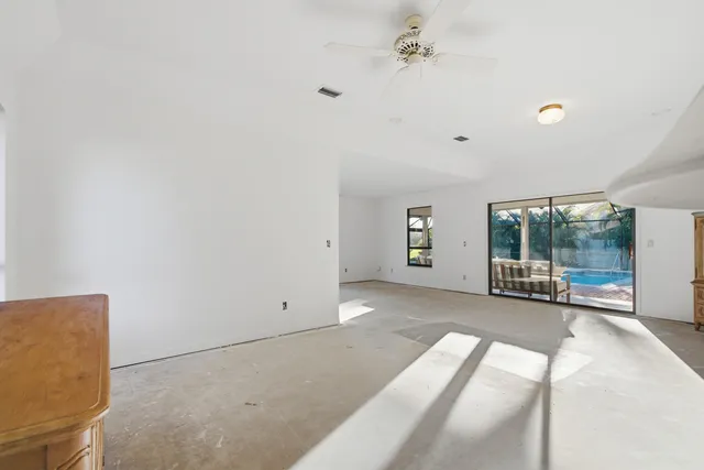a view of a dining room with furniture water chandelier and window
