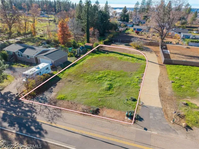 a view of a swimming pool with a yard and plants