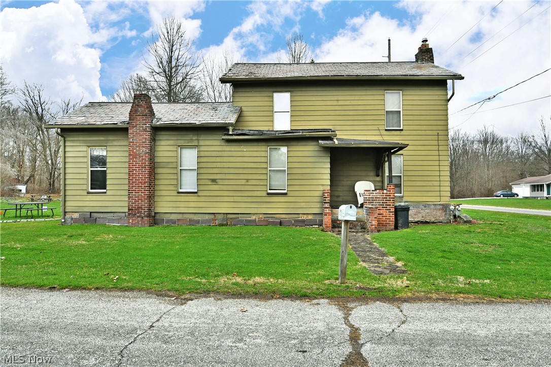 5013 King-Graves Road Vienna, OH 44473 - Photo 1 of 50 Rear view of house with a chimney and a yard