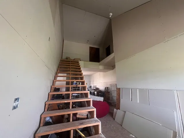 a view of room with stairs and a window