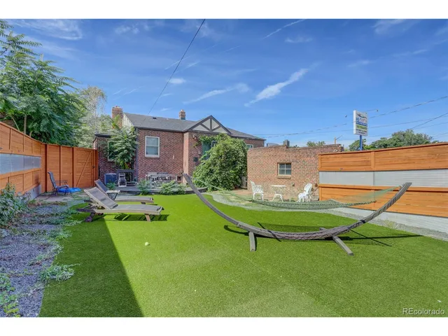 a swimming pool with outdoor seating and yard
