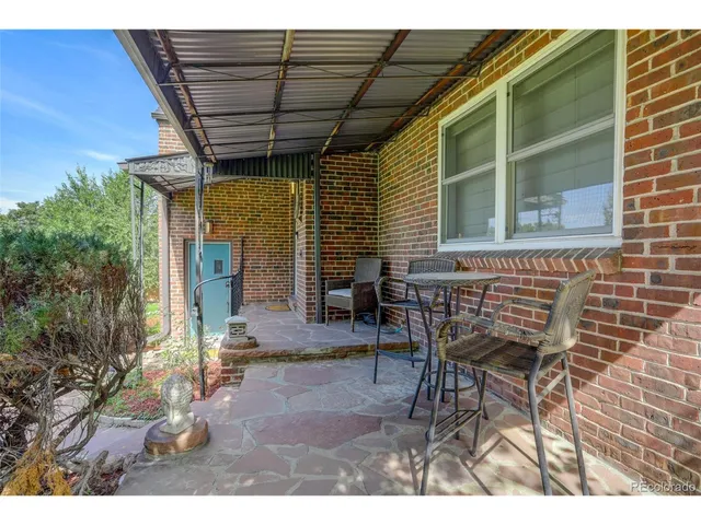 a view of a patio with table and chairs and potted plants