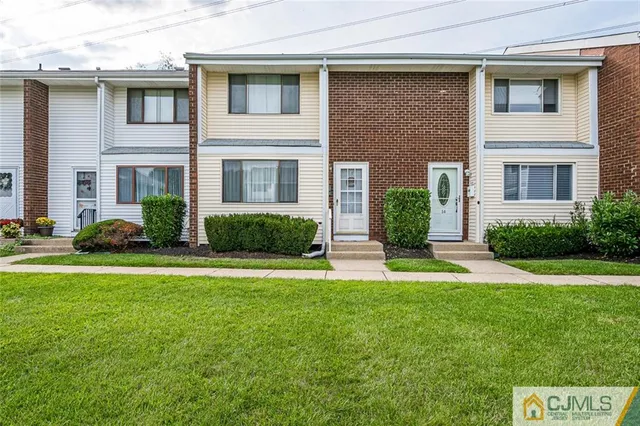 a front view of a house with garage and yard