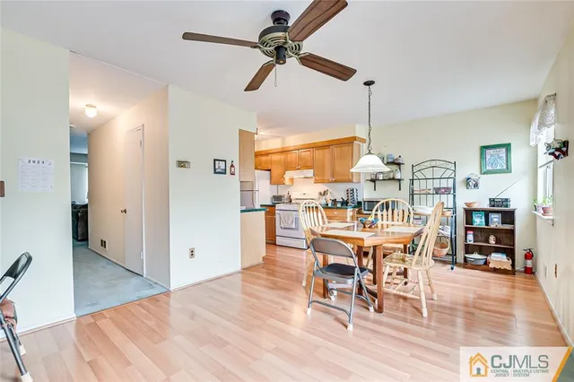 a dining room with furniture a chandelier and wooden floor
