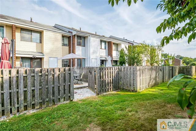 a front view of a house with a garden and plants