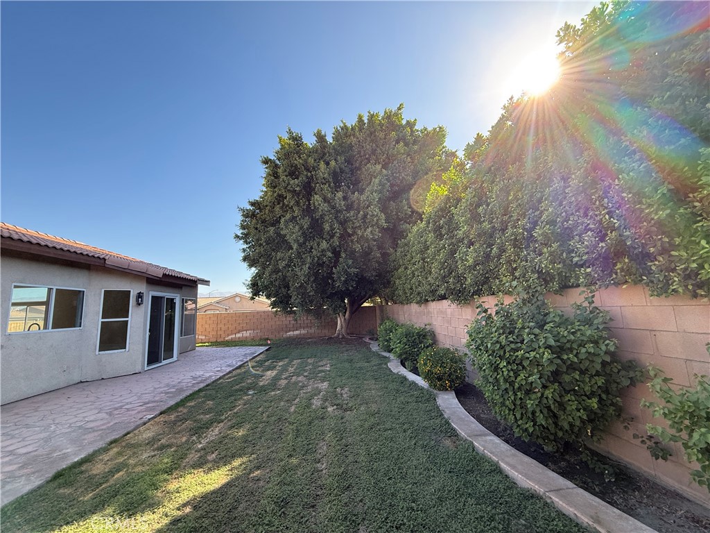 47686 Mirage Way Indio, CA 92201 - Photo 13 of 23 a backyard of a house with lots of green space