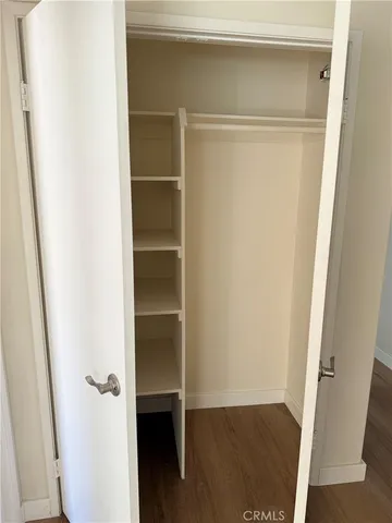 a view of closet with wooden floor