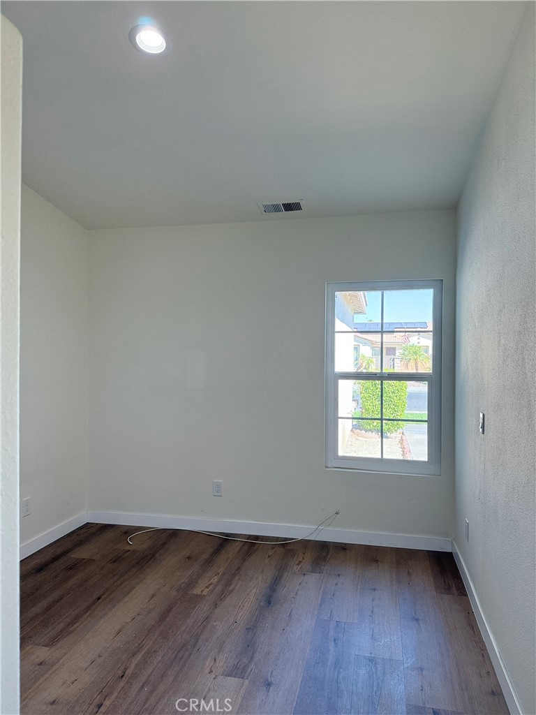 47686 Mirage Way Indio, CA 92201 - Photo 21 of 23 an empty room with wooden floor and window