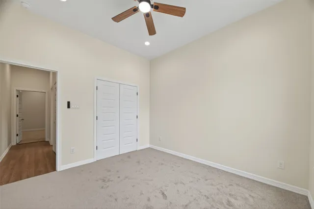 an empty room with a empty space and a ceiling fan