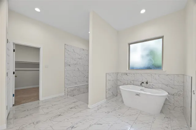 a bathroom with a bathtub and a sink