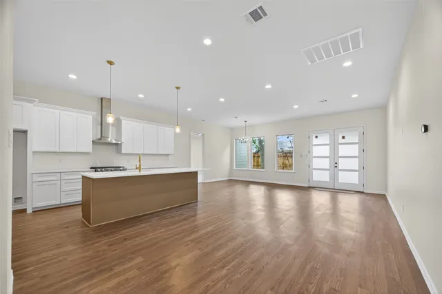 a large kitchen with a lot of counter space and a refrigerator