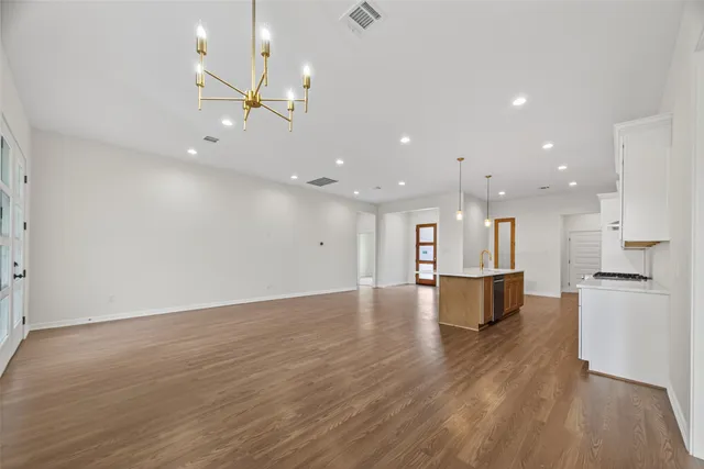 a view of kitchen with a sink dishwasher a refrigerator and wooden floor