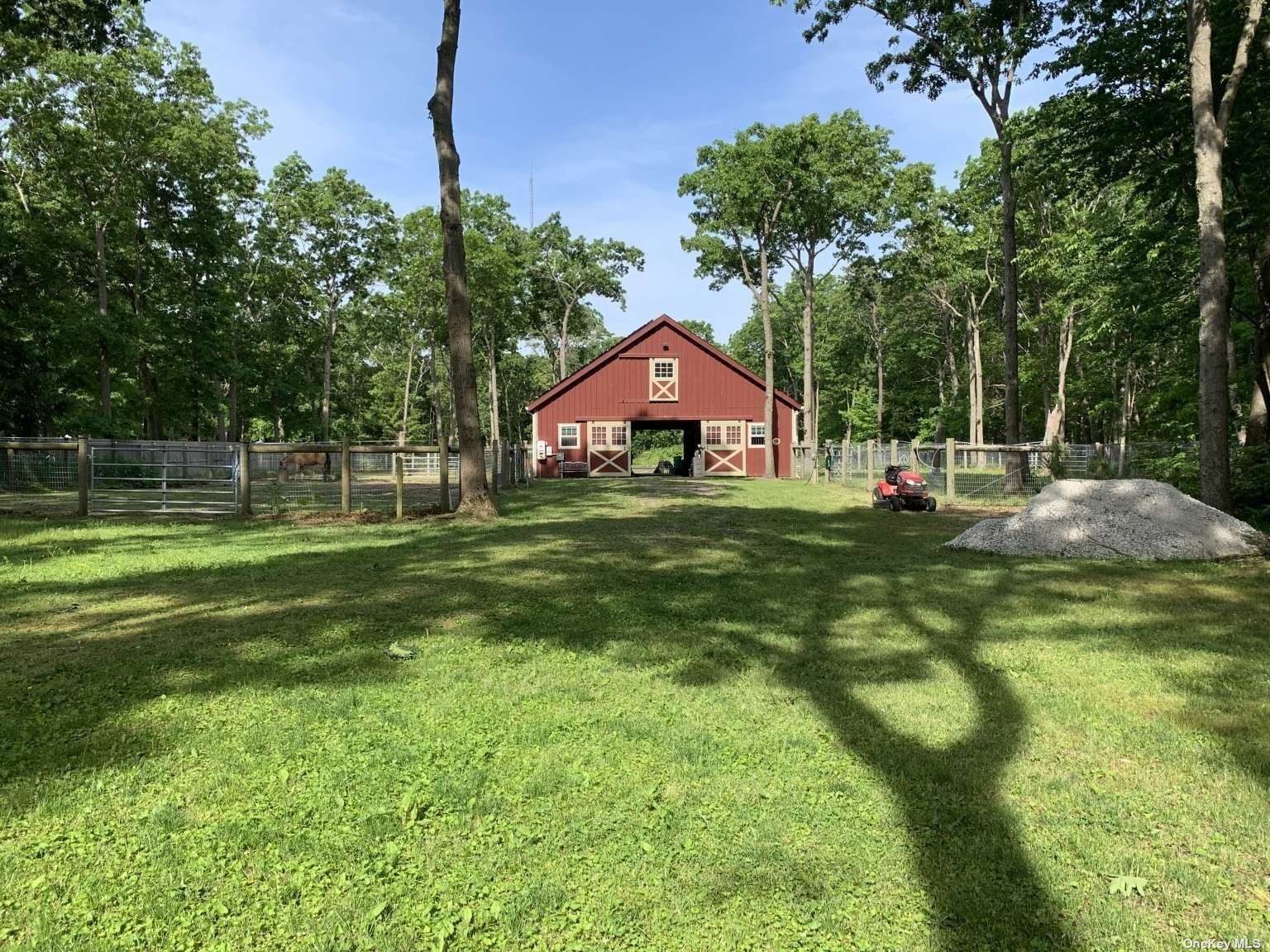 68 Woodlot Road Ridge, NY 11961 - Photo 1 of 1 a backyard of a house with table and chairs