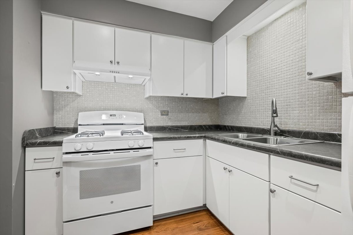 1279 Harding Avenue, Unit 3D Des Plaines, IL 60016 - Photo 12 of 23 a kitchen with granite countertop white cabinets and white appliances
