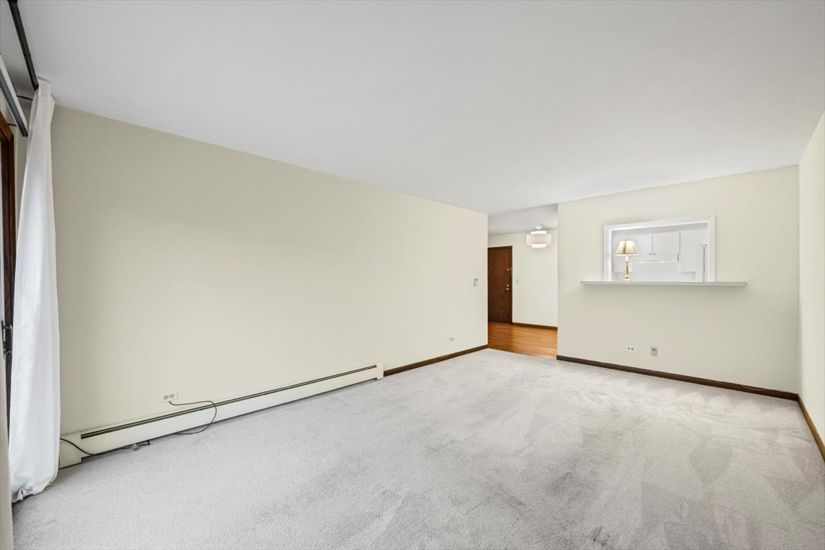 1279 Harding Avenue, Unit 3D Des Plaines, IL 60016 - Photo 9 of 23 an empty room with a empty space and windows