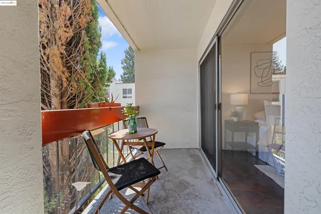 a view of a chairs and table in the balcony