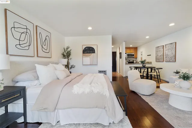 a living room with furniture and a dining table with wooden floor