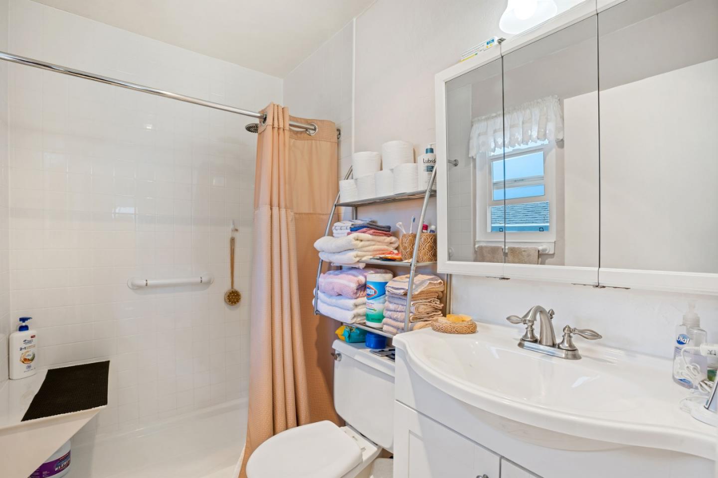 1128 Oddstad Boulevard Pacifica, CA 94044 - Photo 13 of 35 a bathroom with a sink a toilet a shower curtain and a mirror