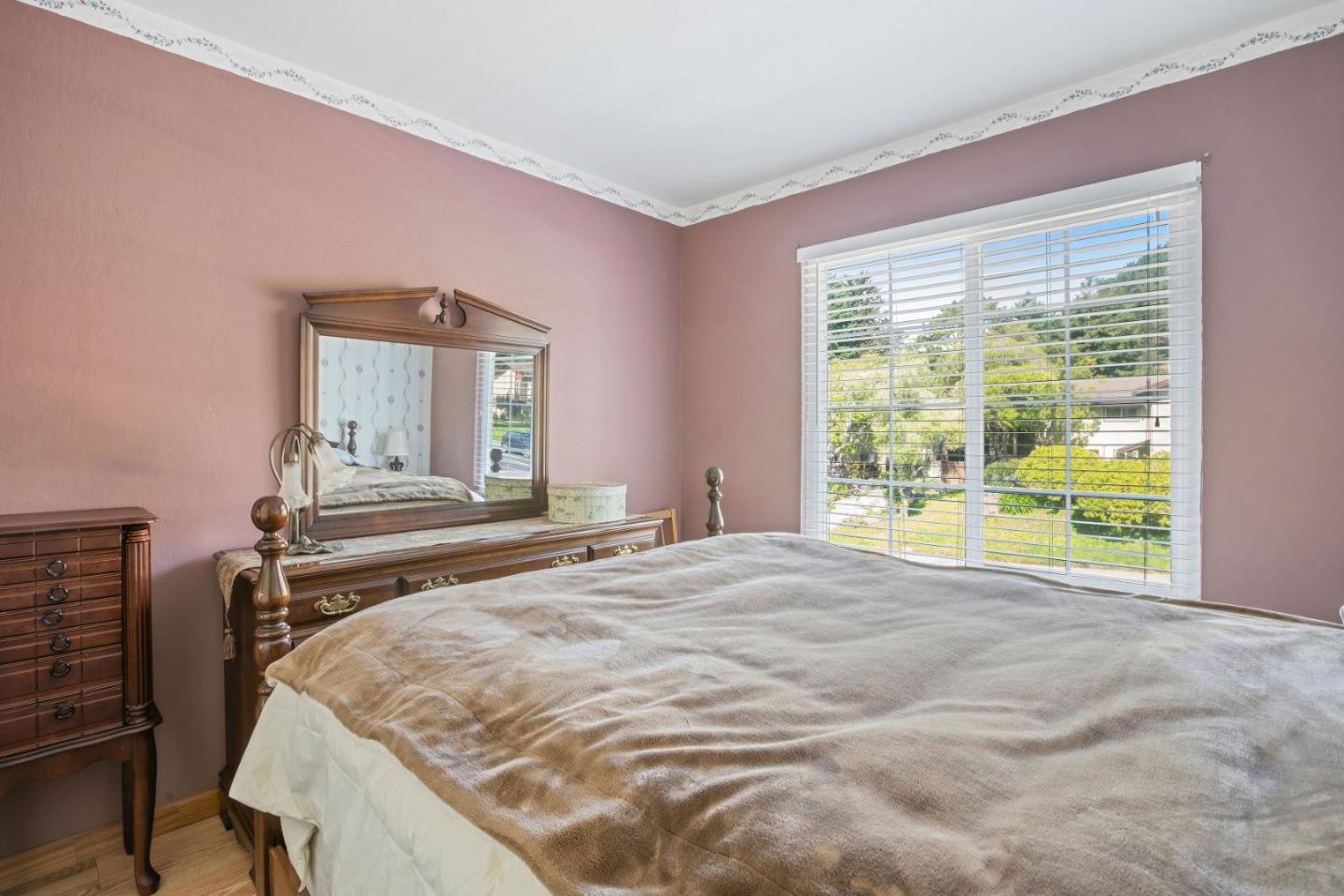 1128 Oddstad Boulevard Pacifica, CA 94044 - Photo 15 of 35 a bedroom with a bed and a window