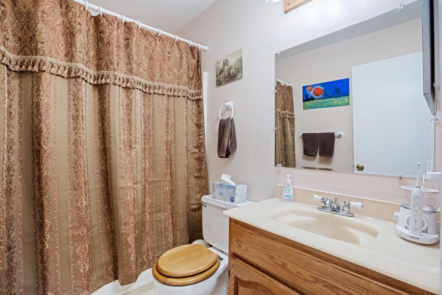 1128 Oddstad Boulevard Pacifica, CA 94044 - Photo 17 of 35 a bathroom with a granite countertop sink and a mirror